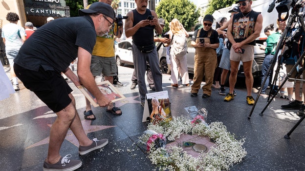 Hollywood mourns the loss of Dolly Parton with memorial flowers at singer's Walk of Fame star