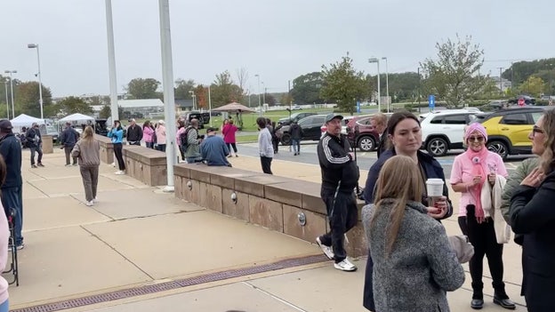 More supporters and spectators stand outside the courthouse.