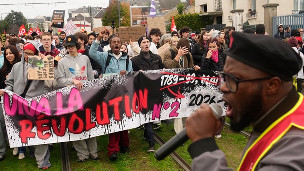 Demonstrators hold a banner reading, “Long live the revolution,” during a protest on the sidelines of the far-right National Rally (RN) congress in Orleans, France, on Saturday, Oct. 24, 2026. (Teresa Suarez/AP)