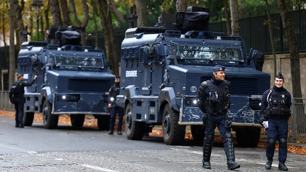 French police officers stand next to armored vehicles of the French Gendarmerie Nationale near the Champs-Elysees avenue in Paris on Saturday, Oct. 24, 2026, ahead of nationwide protests. (Hannah McKay/Reuters)