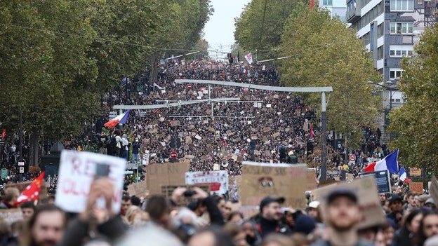 Clashes break out in Paris as police fire water cannons at protesters