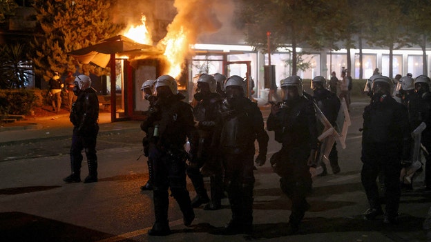 Government buildings set on fire in Albania as riot police clash with agitators