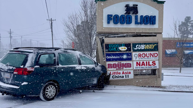 Ice-slicked roads send vehicle into Gastonia, North Carolina Food Lion sign