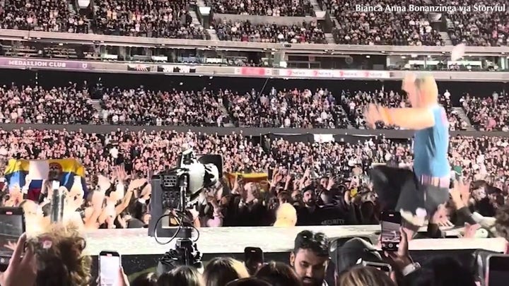 Coldplay's Chris Martin falls through trapdoor.