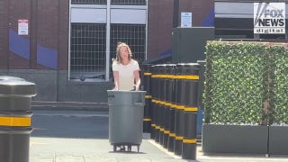 Karen Read takes out the trash behind Boston hotel