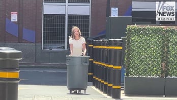 Karen Read takes out the trash behind Boston hotel