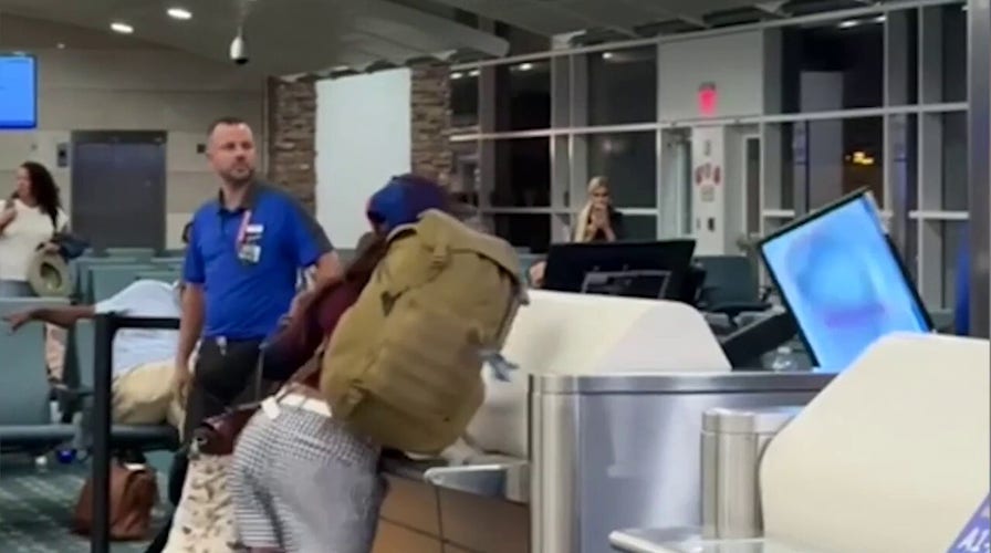 Woman's wild airport tirade caught on camera