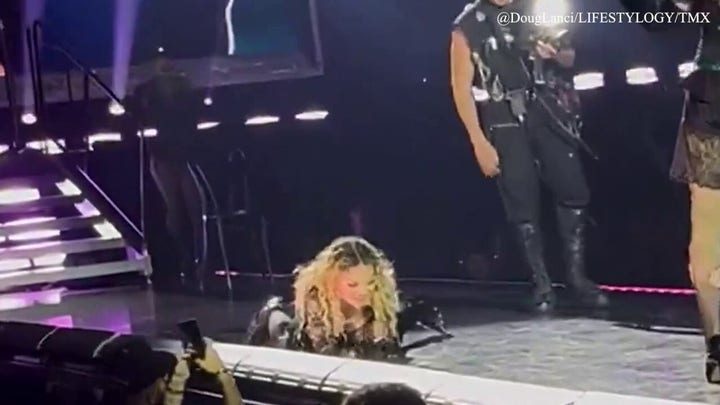 Madonna has an awkward fall onstage while performing 'Open Your Heart'