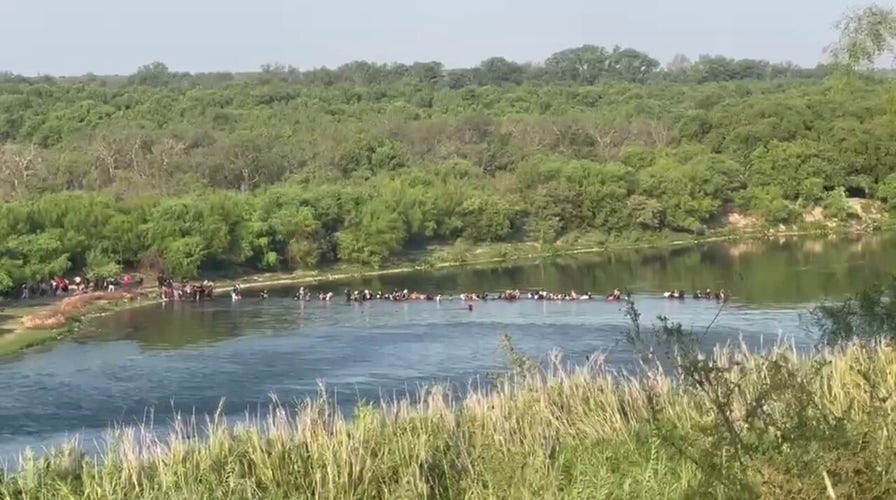 Fox News footage shows migrants walking across the Texas border
