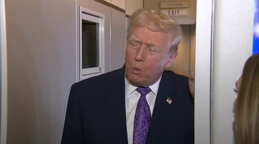  President Trump speaks to reporters aboard Air Force One