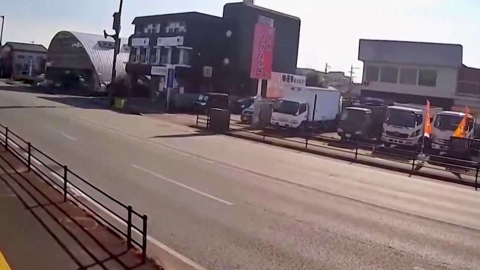 Surveillance video shows trucks shaking during Japan earthquake