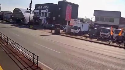 Surveillance video shows trucks shaking during Japan earthquake