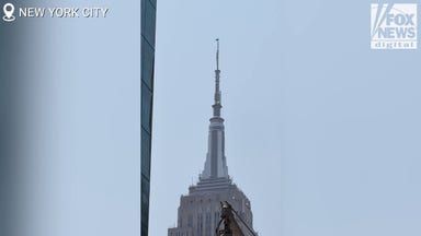 From the ground: Protesters scale Empire State Building, fly flag atop spire