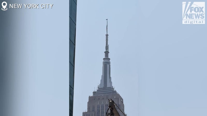 From the ground: Protesters scale Empire State Building, fly flag atop spire