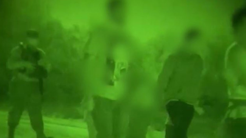Nighttime border footage shows group of adult men and small children discovered by authorities