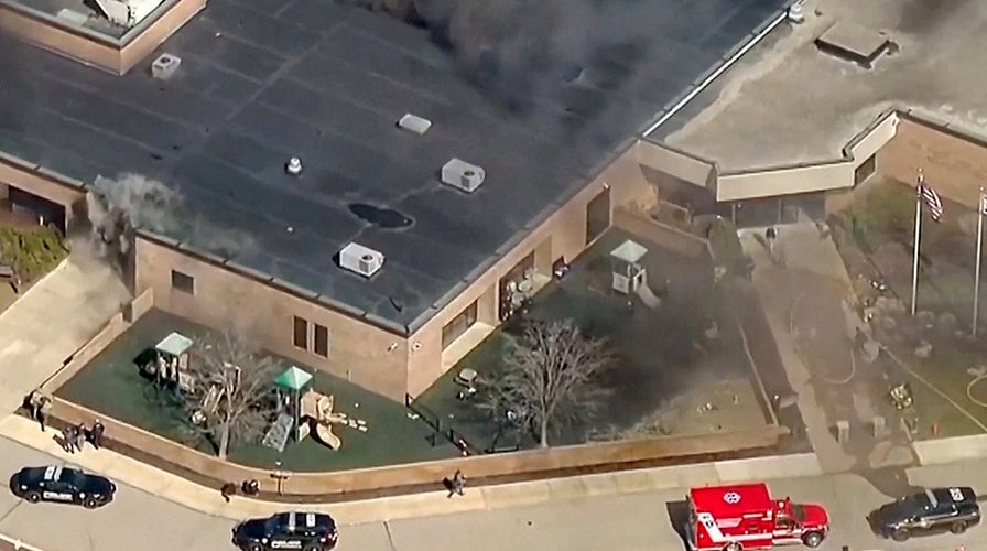  Law enforcement officials clasp  briefing connected  Michigan synagogue attack