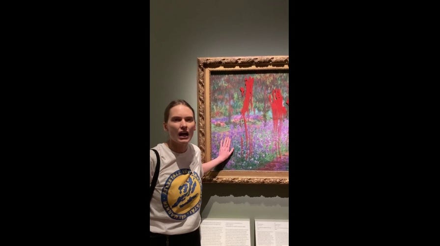 Swedish environmental protesters glue their hands to Monet painting, smear red paint to protest climate change