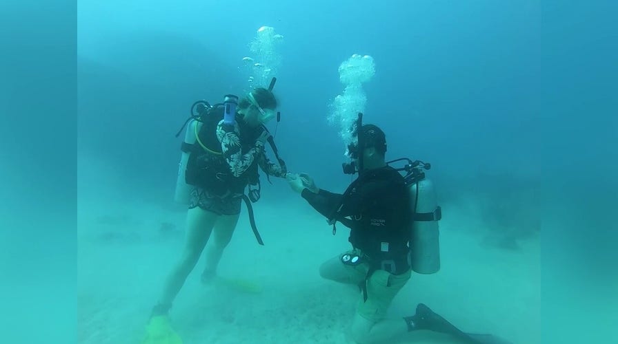 Man proposes 30 meters underwater during Fiji shipwreck dive adventure