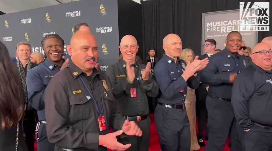 Firefighters walk the red carpet at the 2025 Grammy Awards