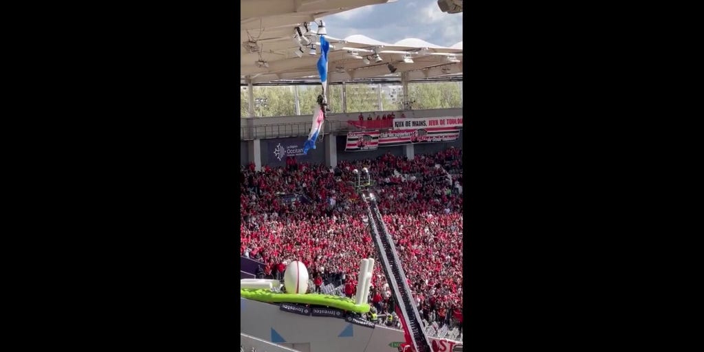 French parachutist dangles from stadium roof before rugby match