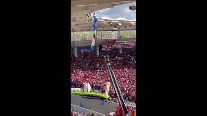 French parachutist dangles from stadium roof before rugby match