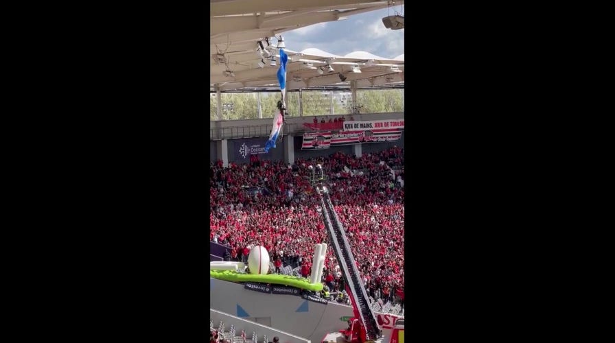 French parachutist dangles from stadium roof before rugby match