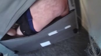 Police bodycam footage reveals suspect hiding inside couch: 'Out you come'