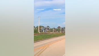 Man lifts railroad gate SAVING woman from oncoming train