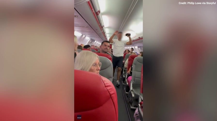 Video Captures Moment Armed Police Escort Man From Plane Due To ...