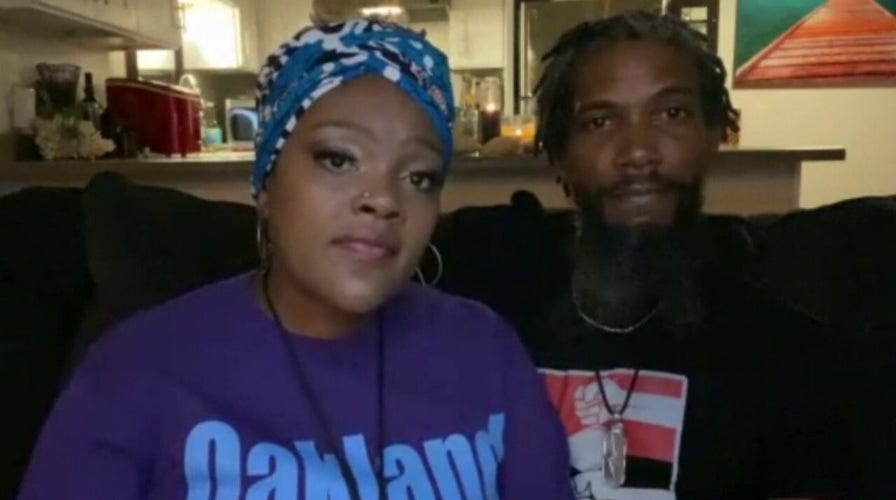 Business owner stands outside her storefront all night to protect it from rioters