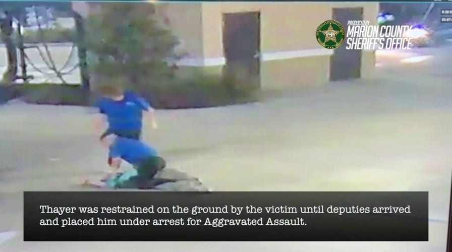 Car lavation  workers subdue ax-wielding antheral   successful  melodramatic  video