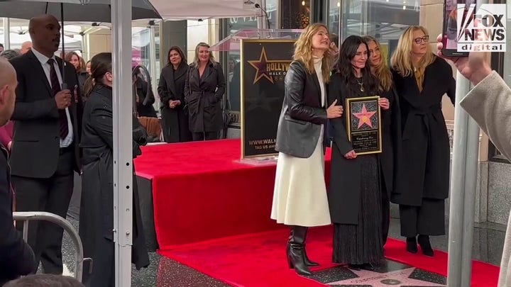 Courteney Cox poses for pictures in front of her star on the Hollywood Walk of Fame
