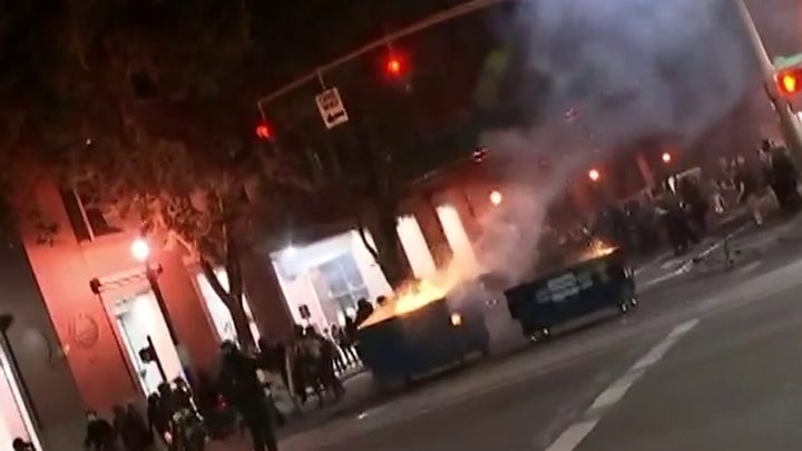 Portland police declare riot after protesters lit fires in dumpsters, broke windows