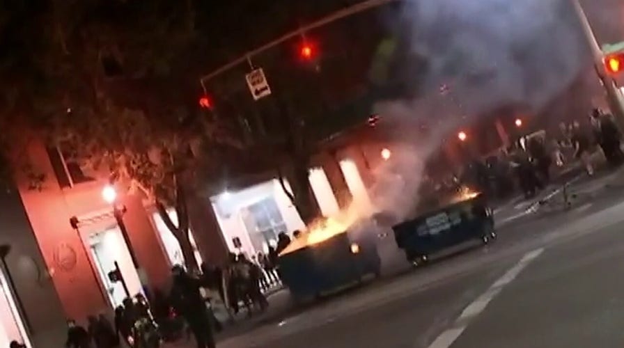 Portland police declare riot after protesters lit fires in dumpsters, broke windows