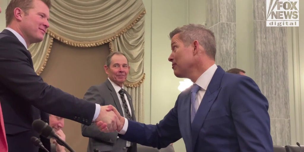 Sean Duffy shakes hands with Senators before his confirmation hearing