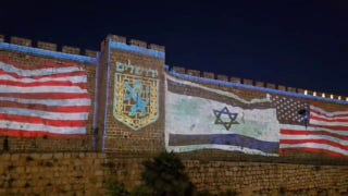 Jerusalem's Old City walls seen illuminated with American, Israeli flags after peace deal