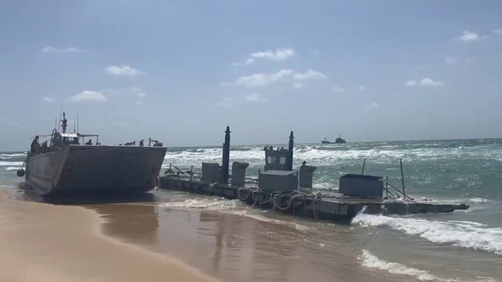 Fox News video shows a beached Navy vessel after botched retrieval of pier piece.