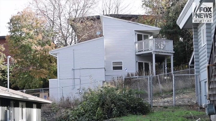 Investigators outside the home where four University of Idaho students were slain in November last year