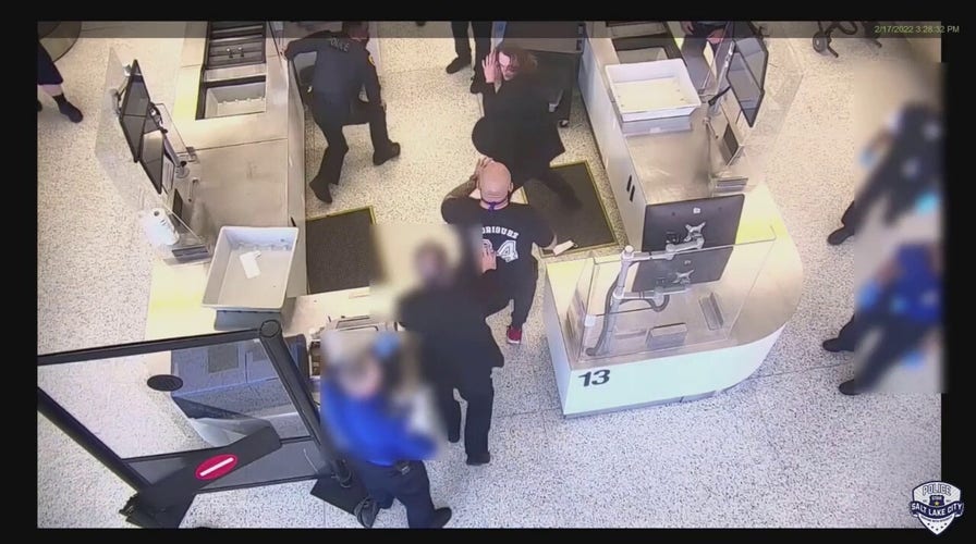 Salt Lake City police officer assaulted at airport, bystander helps subdue suspect, video shows