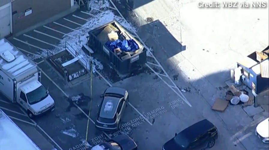 Investigators examine a dumpster near Brown University shooting