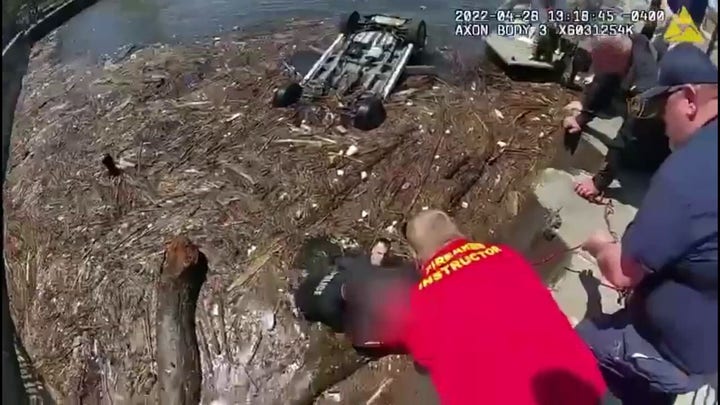 Police release video of officers rescuing woman from submerged vehicle