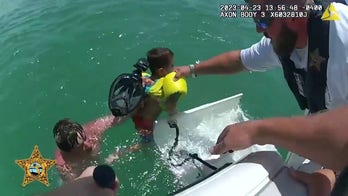 Father and son rescued after being swept away from shore