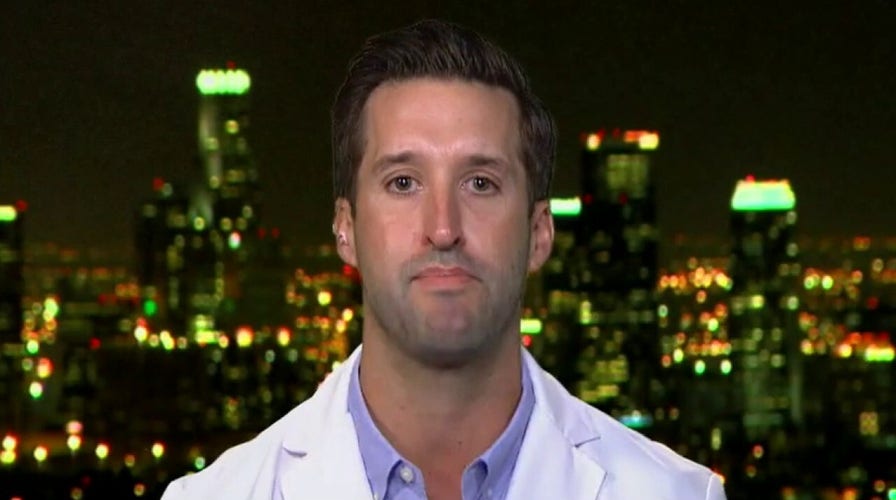 Emergency room physician demonstrates importance of coronavirus face masks