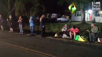 Hecklers outside the home of Leilani Simon