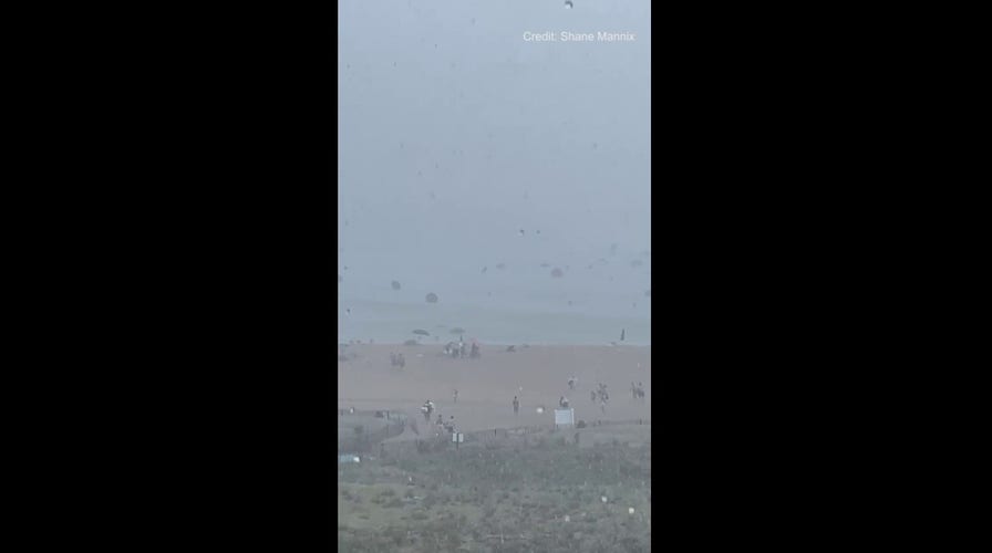 Beach umbrellas blown into the ocean as severe weather hits coastal Delaware