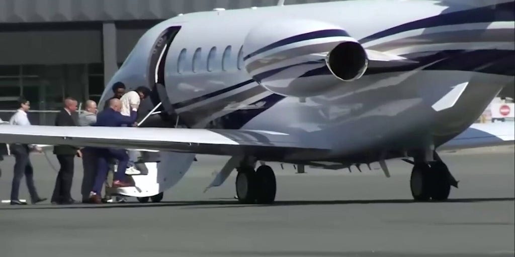 Harjinder Singh boards an airplane as he is extradited to Florida