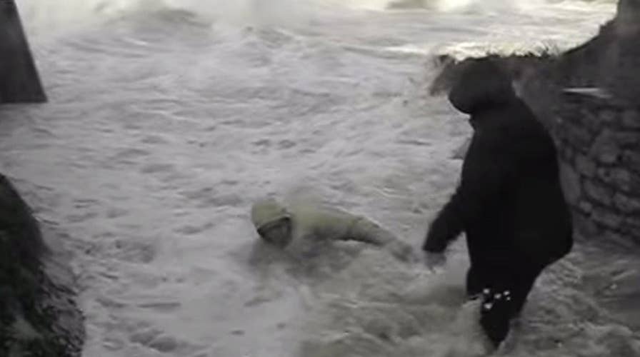 Wicked wave nearly sweeps elderly couple out to sea