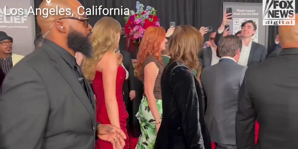Taylor Swift stuns in a red dress while on the 2025 Grammy Awards red carpet