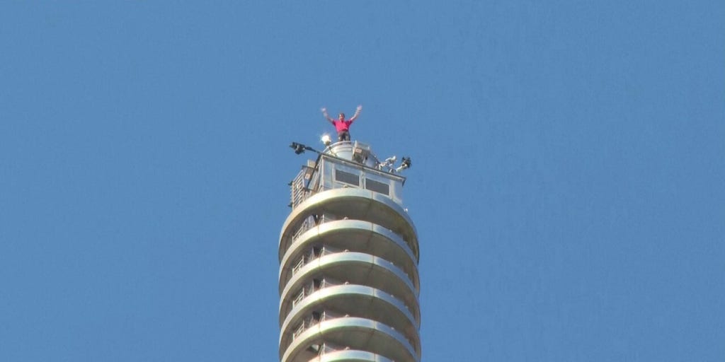 Professional climber Alex Honnold reaches top of Taipei 101 skyscraper without ropes