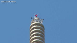 Professional climber Alex Honnold reaches top of Taipei 101 skyscraper without ropes